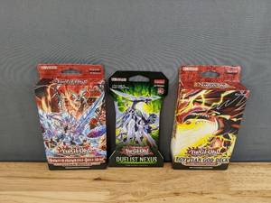 lot 32C image: Brand New YU-GI-OH Structure Deck Albaz Strike, YU-GI-OH TCG Duelist Nexus  9 Card Blister Pack and YU-GI-OH Egyptian God structure deck Slifer the Sky Dragon I