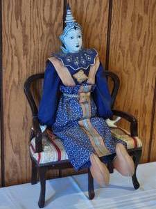 lot 11 image: Unique Indonesian Porcelain Doll in Traditional Dress with Matching Setee
