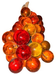 lot 24 image: Amber-hued ornamental Lucite grapes entwined on a vine.