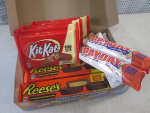 lot 318 image: (C-1) Box of 12 King Size Candy Bars 4 Each of Kit Kat, Pay Day and Reeses Peanut Butter Cups Best by Date Vary March - Aug 2024