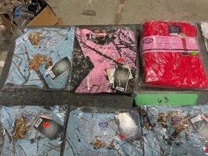TABLE FULL OF MOSSY OAK T-SHIRTS