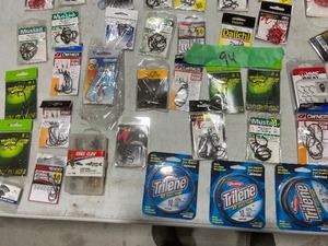TABLE FULL OF FISHING HOOKS & TRILENE LINE