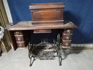 lot 6 image: Antique Domestic pedal controlled sewing machine with drop leaf
