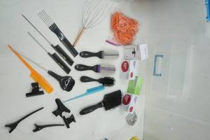 lot 22 image: Professional Hair Brushes, Hair Clips, Bobby Pins, Manicure Jar all in a clear plastic container