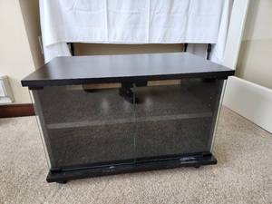 lot 23 image: Black and Glass TV Stand on Casters