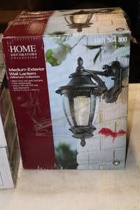 lot 280 image: Home Decorators Collection Wilkerson Collection Medium Exterior Wall Lantern Black Finish with Gold Highlights with Clear Seeded Glass