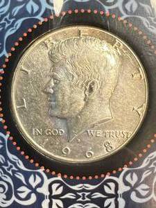 lot 102 image: 1968 US KENNEDY HALF DOLLAR IN INFO. BOOK