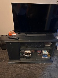 lot 145 image: TV, TV Cabinet, VCR Player and VHS Tapes, DVD Player, and TV Entertainment Stand
