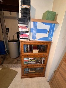 lot 159 image: Glass Front Book Case Filled with Books Includes DVDs and VHS Tapes on Top