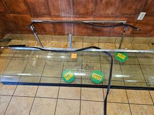 lot 7 image: Commercial Glass Food Display Case with Metal Frame and Marketing Stickers