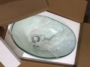 lot 41 image: Solid Tempered Glass Oval Bathroom Vessel Sink in Clear with Chrome Faucet and Pop-Up Drain customer return
