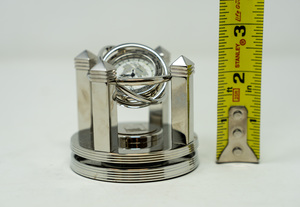 lot 27 image: BENCHMARK The Silver Celestial Quartz Clock. Gyro-rotating. CISCO branded