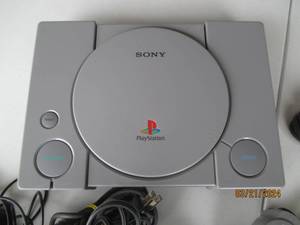 lot 101 image: Sony PlayStation 1 Console with Dual Controllers and Cables