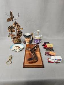 lot 139 image: Musical Copper Flower w Butterflies Plays Love Story, VTG Bottle Opener Deer Design, Mounted Antelope Face, Dish w Fish Design, Lledo Day Gone Truck (Lot of 3), Snow Globe Tara Lipinski