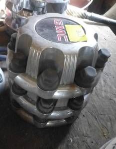 Three GMC hub caps