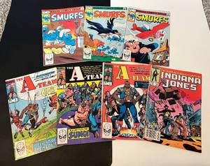 lot 208 image: Marvel Comics Lot of 7 - Smurfs, A-Team, Indiana Jones 1982-1984 Vintage