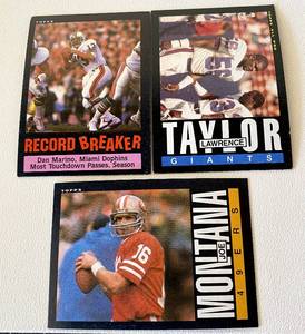 lot 80 image: 1985 Topps Football 3 Star Card Lot - #4 Dan Marino, #124 Lawrence Taylor and #157 Joe Montana Vintage Football Cards