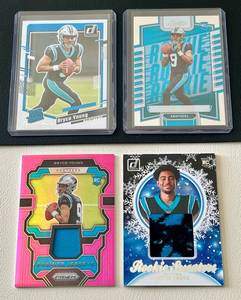 lot 79C image: Lot of 4 Bryce Young Rookie Cards - 2023 RC Panini Prizm Pink Premier Jersey Patch #PJ-BY 2023 RC Panini Donruss Rookie Sweaters Patch #HS-BYO 2023 RC Panini Donruss Rated Rookie Base #311 2023 RC Panini Absolute Base #101