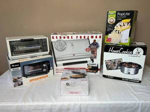 lot KIT19 image: Small Appliance Group - George Foreman Grilling Machine, Waffle Maker, Popcorn Popper, Crock Pot & Toaster Oven Broiler