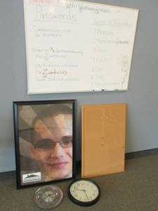 Dry erase board, corkboard, wall clocks and advertisement frame