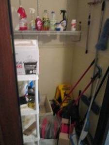 Content of Janitors closet including a variety of cleaners, supplies and plastic shelving unit