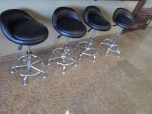 (4) Black padded low back swivel stools with Stainless Metal Base
