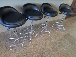(4) Black padded low back swivel stools with Stainless Metal Base