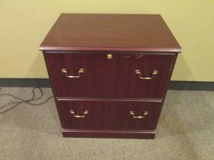 2-drawer Lateral file cabinet in a woodgrain finish with brass tone hardware