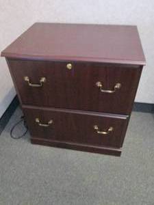 2-drawer Lateral file cabinet in a woodgrain finish with brass tone hardware
