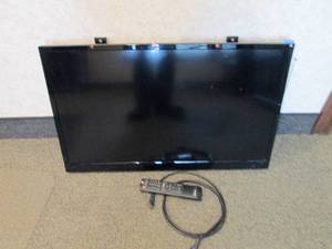 Hiteker 32 flat-screen TV with attached wall mount brackets and remote