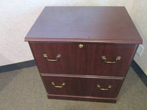 2-drawer Lateral file cabinet in a woodgrain finish with brass tone hardware