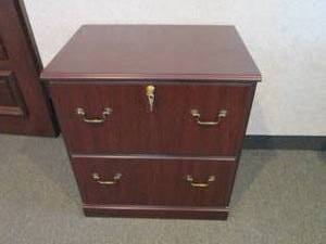2-drawer Lateral file cabinet in a woodgrain finish with brass tone hardware and keys