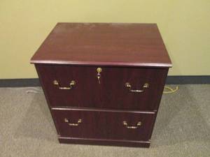 2-drawer Lateral file cabinet in a woodgrain finish with brass tone hardware and keys