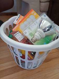 lot 14 image: Laundry Basket of Lightbulbs, Matches & Emergency Candles