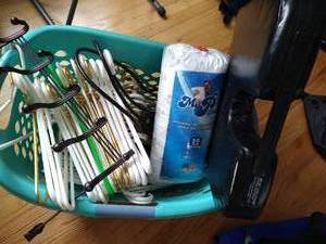 lot 84 image: Basket Filled With Hangers, Over-The-Door Hook, My Pillow, And Orthopedic Seat Cushion