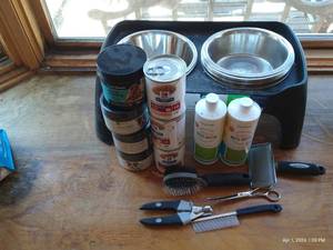lot 244 image: 8 Elevated Feeder With 9 Stainless Steel Bowls, Dog Food, Hemp Calming, Nutra Thrive, Water Additive, Brushes, Comb, And Nail Clippers