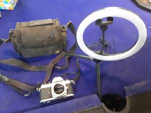 lot 96 image: Nikon camera and bag. Ring light with phone mount