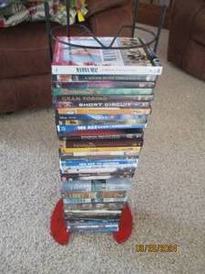 lot 38 image: Wire framed DVD Tower with variety of DVDs for weeks worth of entertainment