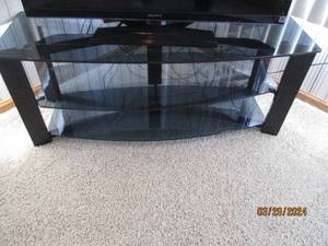 lot 40 image: Black metal framed TV stand with (3) smoked glass tiers (Approximately 451818)
