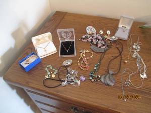 lot 45 image: Assortment of silver and gold tone necklaces, pins and other jewelry containing beads, jewels and other adornments