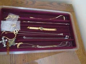 lot 47 image: Sectionalized Felt lined jewelry display case with an assortment of gold and silver toned necklaces, pendants earrings and wristwatch (may or may not contain solid precious metals andor pearlsdiamondsstones