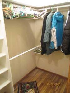 lot 51 image: Content of Master Walk-in containing a variety of womens m-3X outerwear, floor coverings and spare pillows