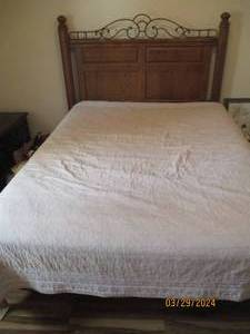 lot 57 image: Queen sized wood Headboard with carved detail and scrolling Metal and nailhead accents
