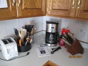 lot 72 image: Small kitchen countertop appliances, knifeblock with knives, canisters of serving utensils, Covered butter dishes and more