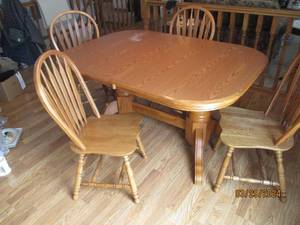 lot 85 image: Light tone wood Dining table and (4) Matching slat back spindle leg chairs