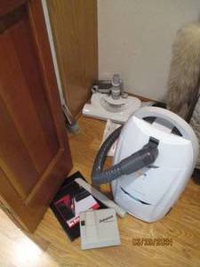 lot 101 image: Kenmore Progressive canister style vacuum cleaner with supplies and accessories shown