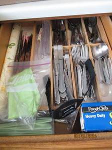 lot 106 image: Drawer full of stainless steel flatware, wood silverware Drawer organizer and other kitchen supplies