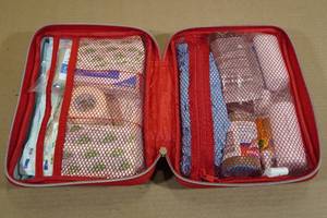 lot 103 image: First Aid Kit Filled with Assorted Medical Supplies