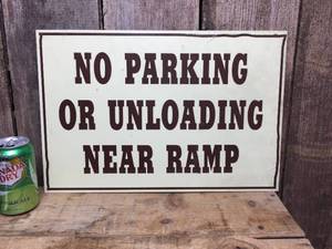 lot 8 image: No Parking or Unloading Near Ramp Metal Sign