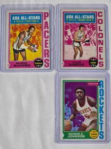 lot 195 image: Lot of 3 1974 Topps NBA Basketball Cards - George McGinnis No. 220, Louie Dampier No. 255, George Johnson No. 54